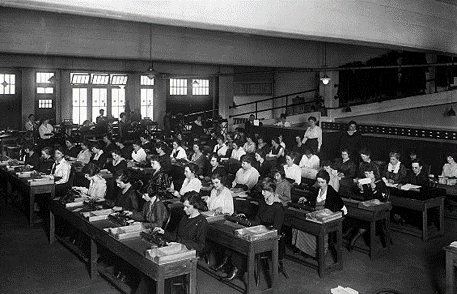 A large room of people sitting at desks in rows